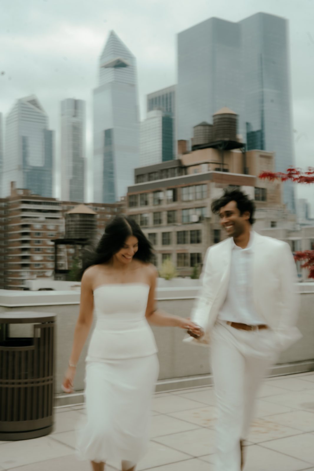 Rohit and Sivani walking, white outfits, city skyline